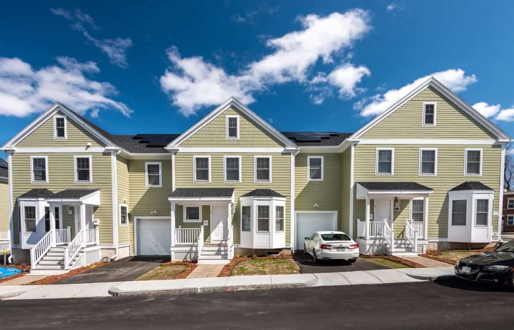 Exterior photo of three townhomes on a sunny day