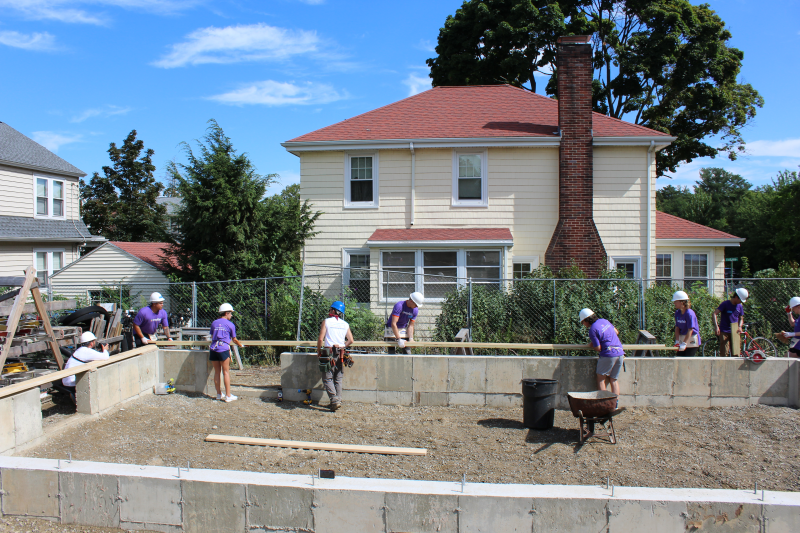 A group of volunteers busy at a build site